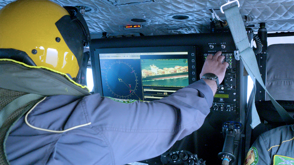 Operator utilizing ATOS mission system on rotary wing platform